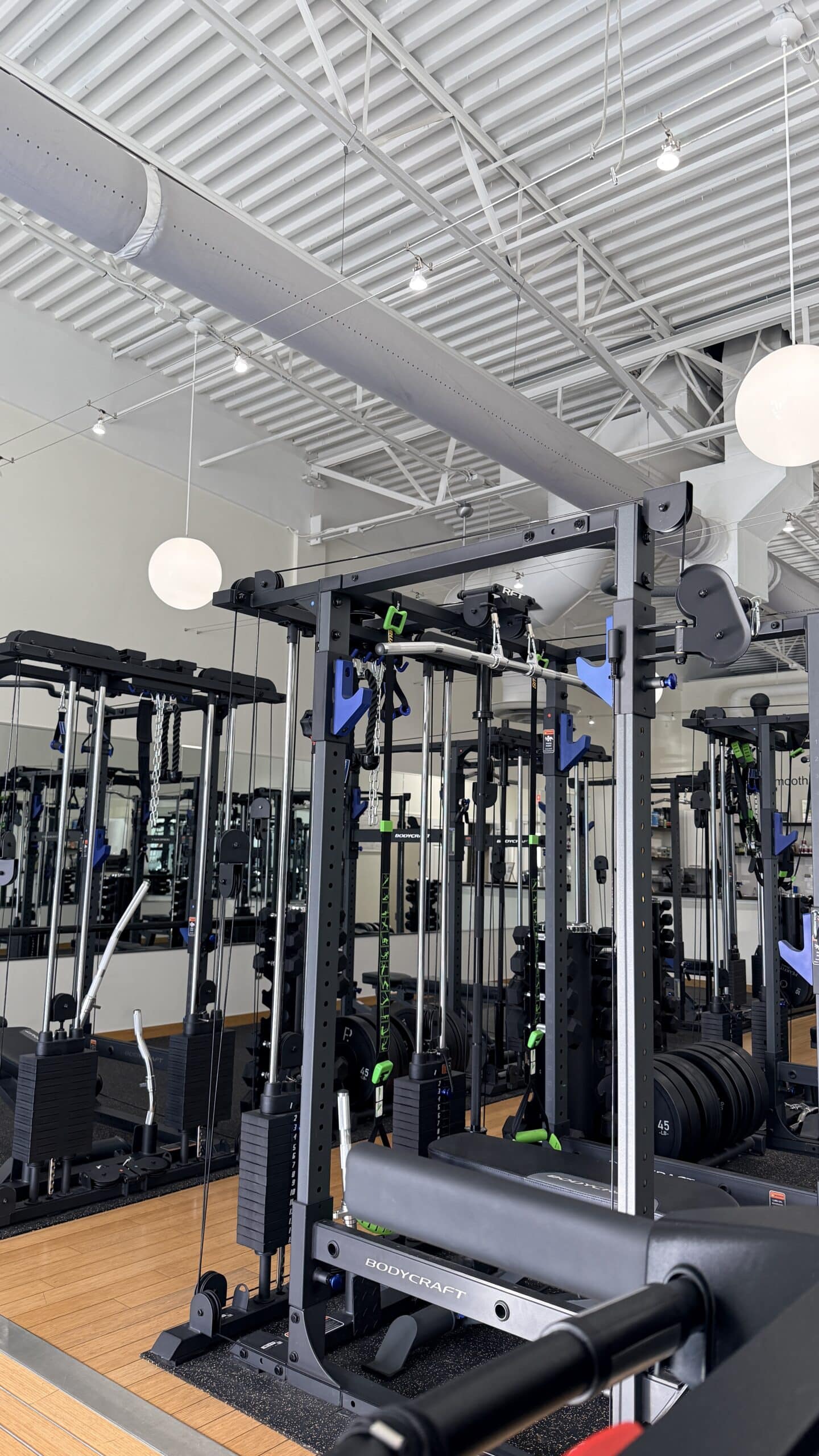 BodyCraft functional trainer cable machine inside a modern personal training studio in Asheville, NC.